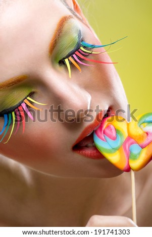 Colorful twisted lollipop and colorful extreme fashion makeup