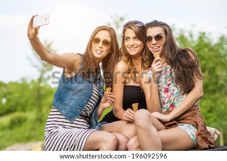 The best friends. Selfie - Three beautiful woman eating ice cream in the City
