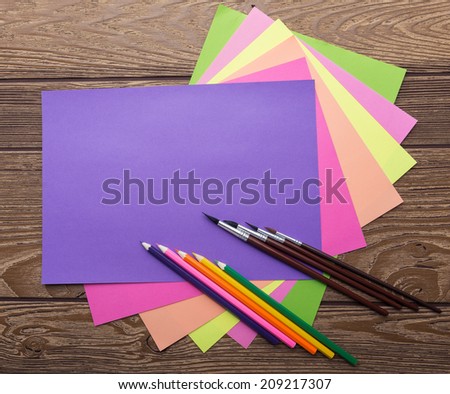 School stationery, cozy colors, paper, pencil, brush, wood background