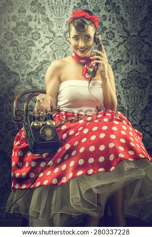 Vintage style - Woman talking with dial phone, in polka dots clothes