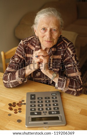 Portrait of senior woman with money and calculator