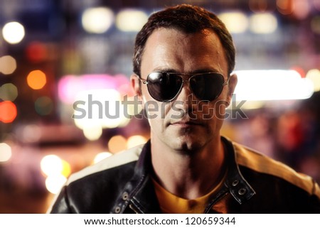 Portrait of handsome tough man in New York city, closeup on face.
