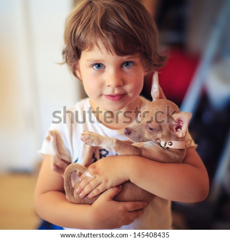 Portrait of toddler girl with baby dog pet Portrait of toddler girl with baby dog pet