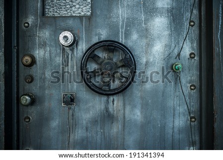 Grunge style image of old metal door background with vault lock.