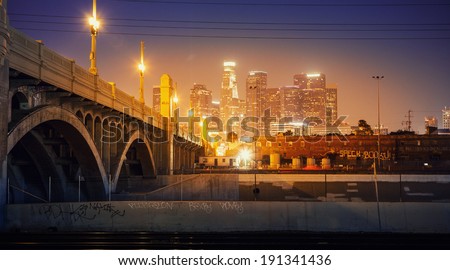 City of Los Angeles at night. Scenic view of downtown skyline with bridge in foreground.