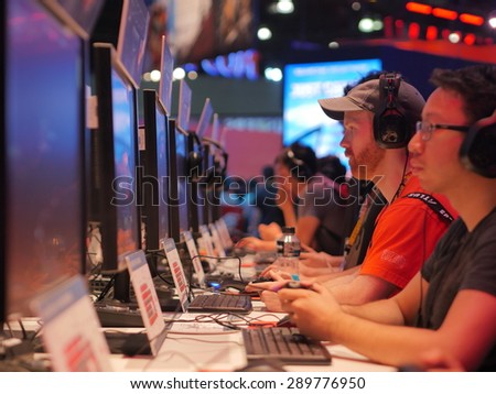 LOS ANGELES - June 17: Gamers playing demo video games at E3 2015 expo. Electronic Entertainment Expo, commonly known as E3, is an annual trade fair for the video game industry