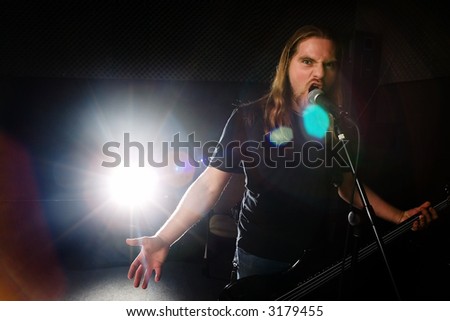 Heavy metal guitarist singing in studio