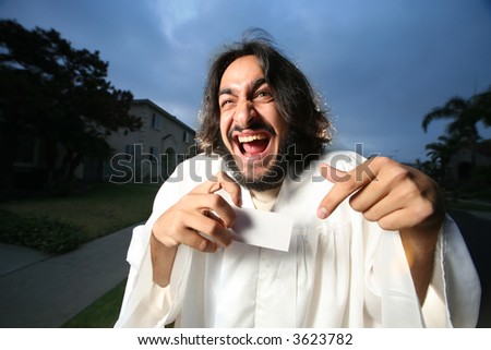 Crazy looking man shownig a blank business card.