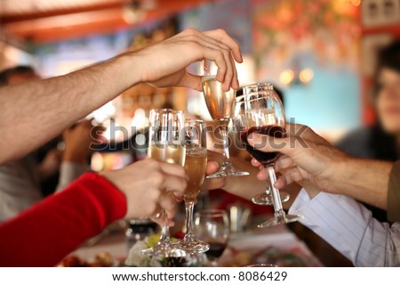 Celebration. Hands holding the glasses of champagne and wine making a toast. Shallow DOF.