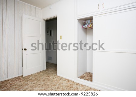 Empty room with white walls and wardrobe closet