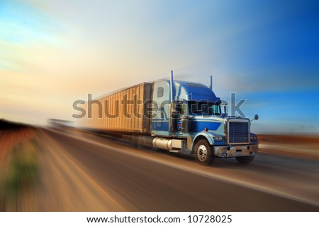 American truck speeding on freeway at sunset, motion blurred.