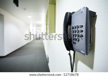 Wall telephone in white corridor