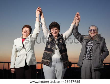 Three women raising hands