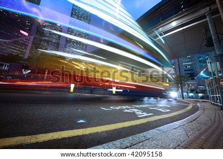 Bus speeding through night street. Hong Kong, China.