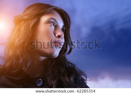 Beautiful asian woman looking up at twilight