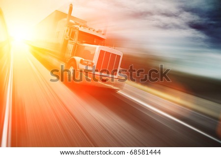 Truck on freeway at sunset. Copyspace.