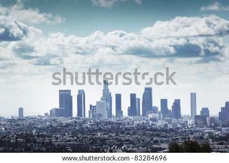 Downtown Los Angeles skyline over blue cloudy sky