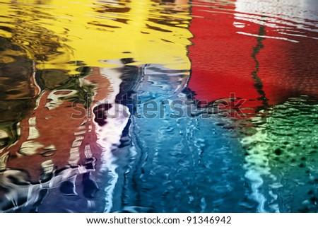 Colorful reflections in rippled spring water background.