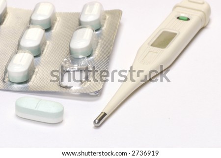 thermometer and pill blisterpack ready to get rid of that fever