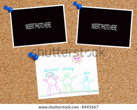 blank photos and child\'s drawing on cork board