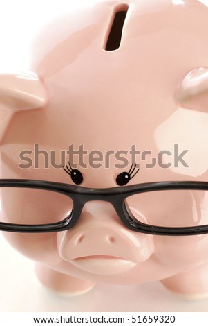 pink piggy bank with sad expression wearing black rimmed glasses on white background