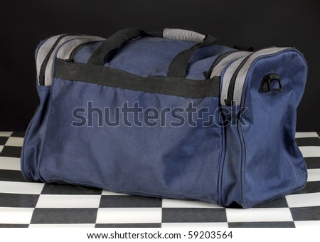 duffel or luggage bag with reflection on black background