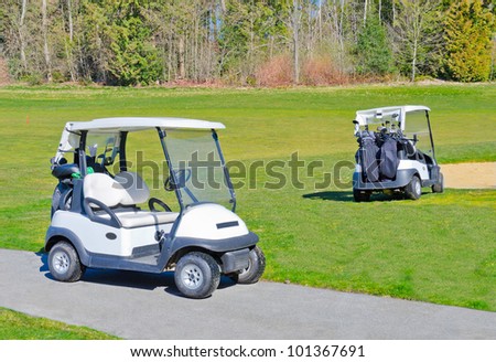 Two carts on the golf course.