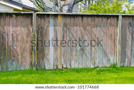 Old looking rustic  (rough ) wooden fence. Touched by weather and time.
