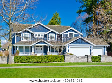 Custom built big luxury house with triple garage doors in a residential neighborhood. Suburbs of Vancouver ( Surrey ) Canada.