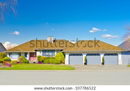 Custom built  big luxury house with three doors garage in a residential neighborhood. Suburbs of Vancouver ( Surrey ) Canada.