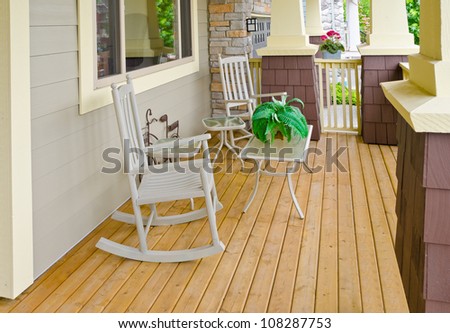 Nicely designed house patio with rocking chairs.