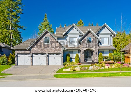 Custom built big luxury house with triple doors garage in a residential neighborhood. Suburbs of Vancouver ( Surrey ) Canada.