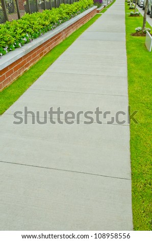 Nice and clean sidewalk, path at the empty street. Neighborhood scenery