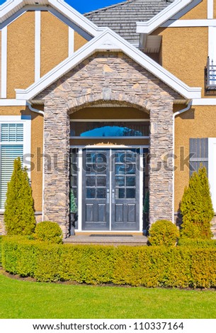 Nicely decorated and landscaped house entrance.  Landscape design
