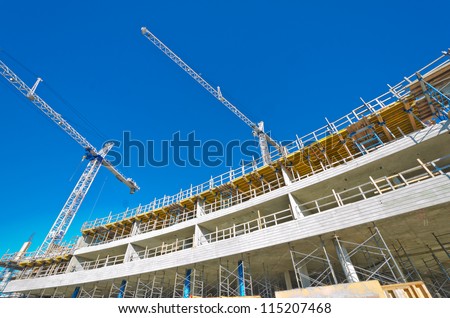 High-Rise Building Under Construction. The Site With Cranes Against Blue Sky. Vancouver, Canada.