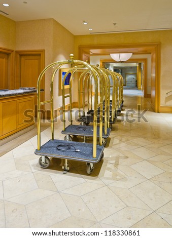 Fragment of the lobby of the luxury five stars hotel with the luggage carts and the counter.