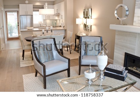 Outlook Of The Luxury Living Suite : Dining Room And The Kitchen At The Back With Two Modern Leather Chairs In Front Of