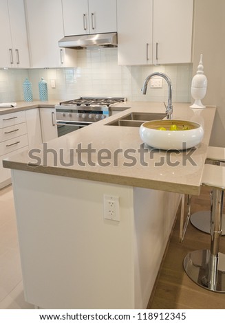 Interior design of a luxury modern kitchen with the dish with some pears on the counter. I