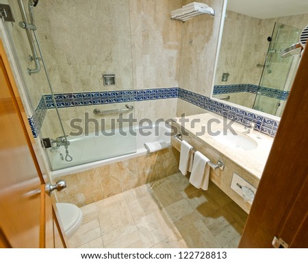 Nicely decorated modern washroom with the toilet and towels in the luxury hotel.