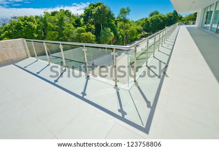 Perspective of the modern glass and steel balcony, deck railing. Exterior, interior design.