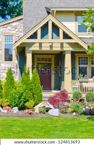House entrance with nicely landscaped front yard.