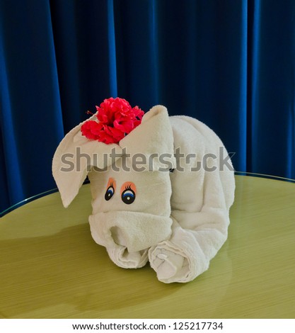 White spa towel twisted ( has been folded out of a towel )  in the form of an puppy, cub, dog.