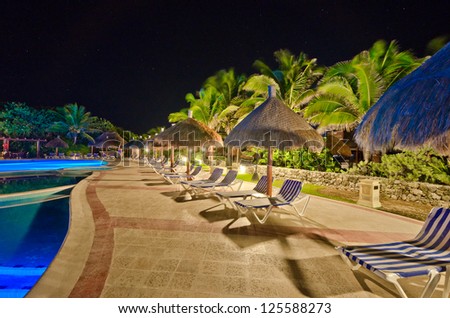 Swimming pool at a luxury caribbean resort at night, dawn time. Bahia Principe, Riviera Maya, Mexican Resort.