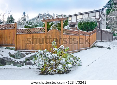Wooden fence in cold,chilly and frosty winter time covered with snow . Vancouver, Canada.