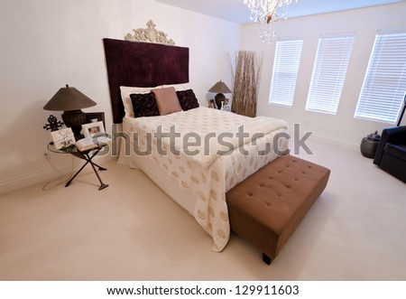 Nicely decorated contemporary bedroom at the day time. Interior design. Vertical.
