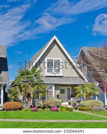 Suburban middle  class home with nicely landscaped front yard lawn