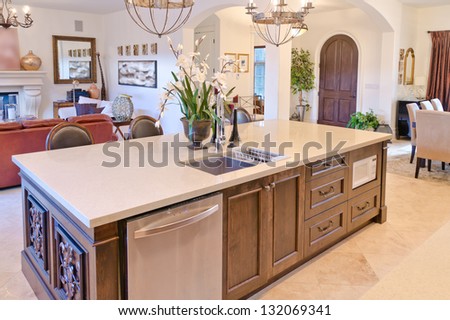 Interior design of a luxury modern kitchen with the vase with some flowers on the counter.