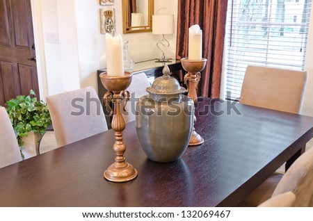 Candelabrums and vase on the living        ( lunch ) room table. Interior design.
