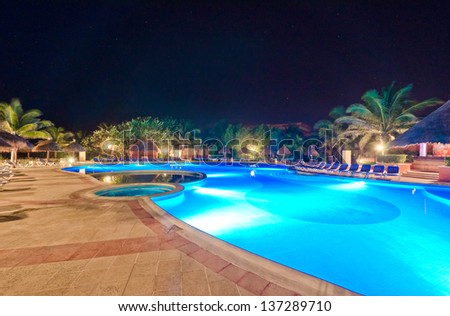 Swimming pool at a luxury caribbean resort at night, dawn time. Bahia Principe, Mexican Resort.