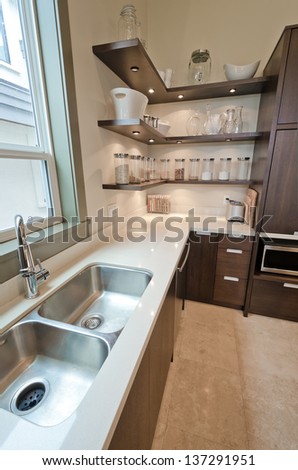 Fragment of the luxury modern kitchen with some shelves with  jars, cans in the corner. Interior design. Vertical.